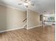 Open-concept living area with updated floors, access to the kitchen, and a staircase leading to the upper level at 4465 E Paradise Village S Pkwy # 1224, Phoenix, AZ 85032