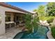 An expansive backyard with pool, lush landscaping, and covered patio, providing ample space for relaxation and entertainment at 4548 E Nightingale Ln, Gilbert, AZ 85298