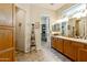 Bathroom featuring a double vanity, tile floors, and walk-in closet with extensive shelving at 4548 E Nightingale Ln, Gilbert, AZ 85298