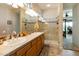 Bathroom featuring double sinks with a glass enclosed shower and decorative tile accents at 4548 E Nightingale Ln, Gilbert, AZ 85298