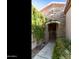 Stone archway entrance with wrought iron gate, framed by lush plants and greenery at 4548 E Nightingale Ln, Gilbert, AZ 85298