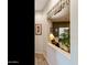 Hallway leading to a cozy sitting area with a plush sofa and views of the outdoors at 4548 E Nightingale Ln, Gilbert, AZ 85298