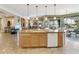 Expansive kitchen island with dishwasher and sink offers ample counter space and easy access to dining area at 4548 E Nightingale Ln, Gilbert, AZ 85298