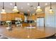 Bright kitchen features modern appliances, granite countertops and pendant lighting above a spacious island at 4548 E Nightingale Ln, Gilbert, AZ 85298