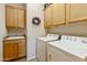 Functional laundry room equipped with a sink, cabinets, and a washer and dryer at 4548 E Nightingale Ln, Gilbert, AZ 85298