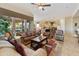 Inviting living room with modern ceiling fan, stylish furnishings, and seamless kitchen access at 4548 E Nightingale Ln, Gilbert, AZ 85298