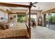 Spacious main bedroom with decorative canopy bed, backyard views and stylish furnishings at 4548 E Nightingale Ln, Gilbert, AZ 85298