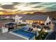 Aerial view showcases a stunning backyard with a pool, spa, and outdoor living spaces at 460 W Chase St, San Tan Valley, AZ 85143