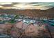 Aerial view of a property with a pool, surrounded by desert landscape and the outline of the property at 460 W Chase St, San Tan Valley, AZ 85143