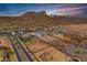 Aerial shot showcases the home's layout, including the pool, backyard, and surrounding desert landscape at 460 W Chase St, San Tan Valley, AZ 85143