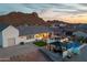 Aerial view of the home, pool, backyard putting green, and outdoor living space at sunset at 460 W Chase St, San Tan Valley, AZ 85143