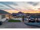 Expansive backyard features a custom pool, a putting green, an outdoor kitchen, and lush desert landscaping at 460 W Chase St, San Tan Valley, AZ 85143