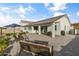 Expansive backyard with a covered patio, outdoor seating, and lush landscaping at 460 W Chase St, San Tan Valley, AZ 85143