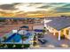Beautiful backyard with a luxurious pool, gazebo, lush landscaping, and comfortable patio furniture at 460 W Chase St, San Tan Valley, AZ 85143