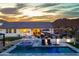 Backyard featuring pool and jacuzzi, covered patio, and lush landscaping at 460 W Chase St, San Tan Valley, AZ 85143