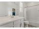 Bright bathroom featuring a white vanity, a framed mirror, and a shower-tub combination with a white shower curtain at 460 W Chase St, San Tan Valley, AZ 85143