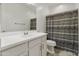 Bathroom featuring a vanity, a large mirror, and a shower-tub combination with a grey and white patterned shower curtain at 460 W Chase St, San Tan Valley, AZ 85143