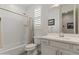 Bright bathroom featuring a white vanity, a framed mirror, and a shower-tub combination with a patterned shower curtain at 460 W Chase St, San Tan Valley, AZ 85143
