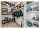 Walk-in closet showcasing LEGO sets, built-in shelving, and hanging storage, providing organized and ample storage space at 460 W Chase St, San Tan Valley, AZ 85143
