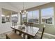 Bright dining room features a stylish light fixture and views of the backyard oasis at 460 W Chase St, San Tan Valley, AZ 85143