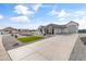 Well-kept desert home featuring professional landscaping, a paver driveway, and attached three car garage at 460 W Chase St, San Tan Valley, AZ 85143