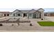 Stunning desert home showcasing modern landscaping featuring rock accents and a well-manicured lawn at 460 W Chase St, San Tan Valley, AZ 85143