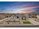 Stunning single-story home with desert landscaping, side-entry garage, and mountain views against a vibrant sunset sky at 460 W Chase St, San Tan Valley, AZ 85143