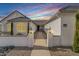 Inviting walkway leads to a charming home featuring decorative pillars, manicured landscaping, and well-lit entry at 460 W Chase St, San Tan Valley, AZ 85143