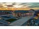 Striking aerial view of a desert home highlighting the manicured landscaping and paver driveway at 460 W Chase St, San Tan Valley, AZ 85143