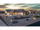 Stunning home exterior with a well-lit driveway, desert landscaping, and architectural details at dusk at 460 W Chase St, San Tan Valley, AZ 85143