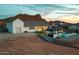 View of the back exterior featuring a pool, putting green, gazebo, and a desert landscape backdrop at 460 W Chase St, San Tan Valley, AZ 85143