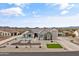 Beautiful desert home featuring professional landscaping, a paver driveway, and an attached three car garage at 460 W Chase St, San Tan Valley, AZ 85143