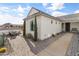 Beautiful desert home highlighting the paver patio, landscaping, and custom front door at 460 W Chase St, San Tan Valley, AZ 85143
