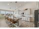 Bright and spacious kitchen features granite countertops, stainless steel appliances, and a stylish island with seating at 460 W Chase St, San Tan Valley, AZ 85143