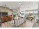 Open-concept kitchen flows into the living area, featuring a large island and views of the outdoor dining at 460 W Chase St, San Tan Valley, AZ 85143