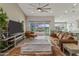 Open-concept living space boasts modern furnishings, a large tv, and seamless access to the outdoor pool area at 460 W Chase St, San Tan Valley, AZ 85143