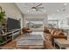 Spacious living room with views of the backyard, comfortable seating, and a modern entertainment center at 460 W Chase St, San Tan Valley, AZ 85143