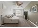 Comfortable living room with a sectional sofa, ceiling fan, and a view of the landscape at 460 W Chase St, San Tan Valley, AZ 85143