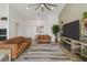 Bright living room with modern ceiling fan, large TV, and comfortable seating at 460 W Chase St, San Tan Valley, AZ 85143