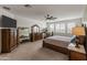 Spacious main bedroom featuring elegant furnishings, a ceiling fan, and natural light from shuttered windows at 460 W Chase St, San Tan Valley, AZ 85143