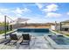 Gorgeous private pool and spa with sleek tile, waterfall feature, and lounging area, perfect for relaxation at 460 W Chase St, San Tan Valley, AZ 85143