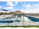 Beautiful pool with spa and waterfall feature, set against a backdrop of blue skies and distant mountains at 460 W Chase St, San Tan Valley, AZ 85143