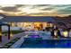 Inviting pool and spa area with a waterfall feature, a covered outdoor dining space, and desert landscaping at 460 W Chase St, San Tan Valley, AZ 85143