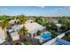 An aerial view of a well-maintained home featuring a backyard diving pool, outdoor seating area, and mature landscaping at 462 N Bedford Ct, Chandler, AZ 85225