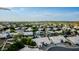 An aerial shot displays a neighborhood featuring green trees and well-maintained houses with white roofs at 462 N Bedford Ct, Chandler, AZ 85225