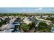 An aerial view of a suburban neighborhood featuring lush green trees and well-maintained houses with white roofs at 462 N Bedford Ct, Chandler, AZ 85225