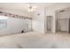 Large bedroom with ceiling fan, ample natural light, and neutral carpeting at 462 N Bedford Ct, Chandler, AZ 85225