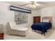 Cozy bedroom features natural light and a seating area with a comfy chair at 462 N Bedford Ct, Chandler, AZ 85225