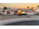 Charming single-story home showcasing manicured desert landscaping and a warm, inviting entrance at sunset at 462 N Bedford Ct, Chandler, AZ 85225