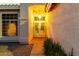 Elegant front entrance with decorative glass doors, lush greenery, and inviting lighting at 462 N Bedford Ct, Chandler, AZ 85225